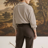 graced Tracy striped polo top with lace collar trim worn by a model with dark trousers in a studio setting