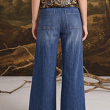 graced washed dark denim wide-leg pants with back pockets worn by a woman with a floral top
