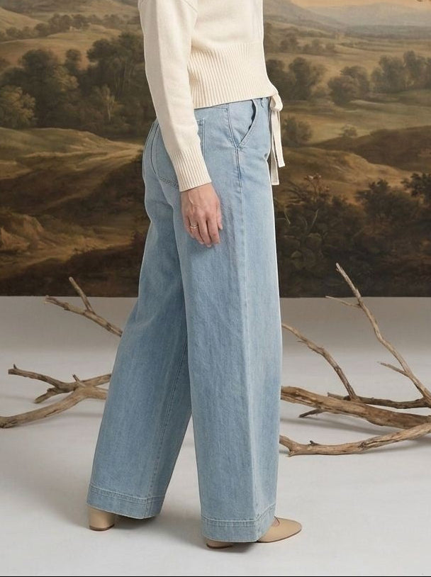 graced washed denim tie-front pants in light blue worn by a blonde model with a cream sweater and neutral heels