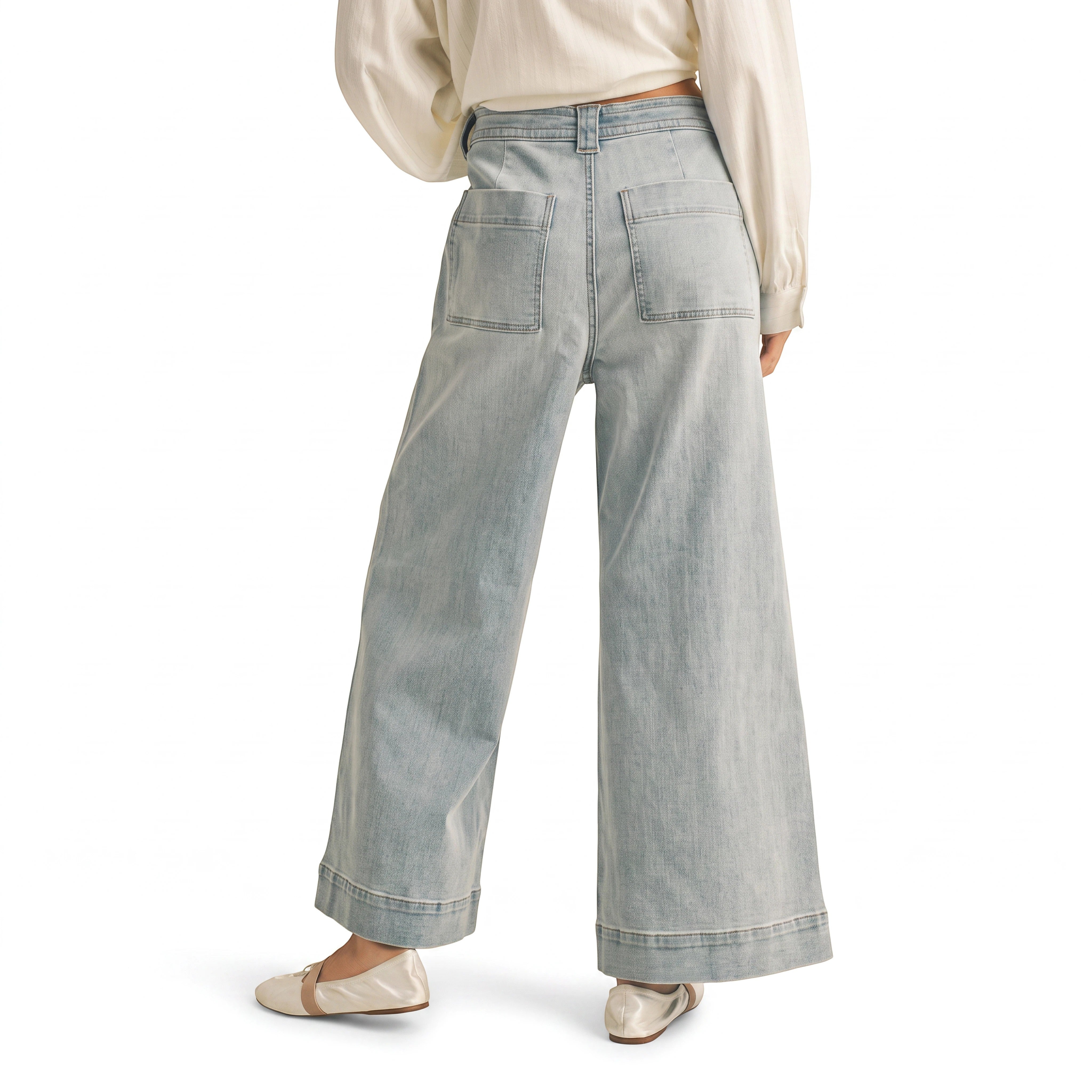 graced washed denim pants with a relaxed wide-leg fit and back pockets worn with a white top and ballet flats