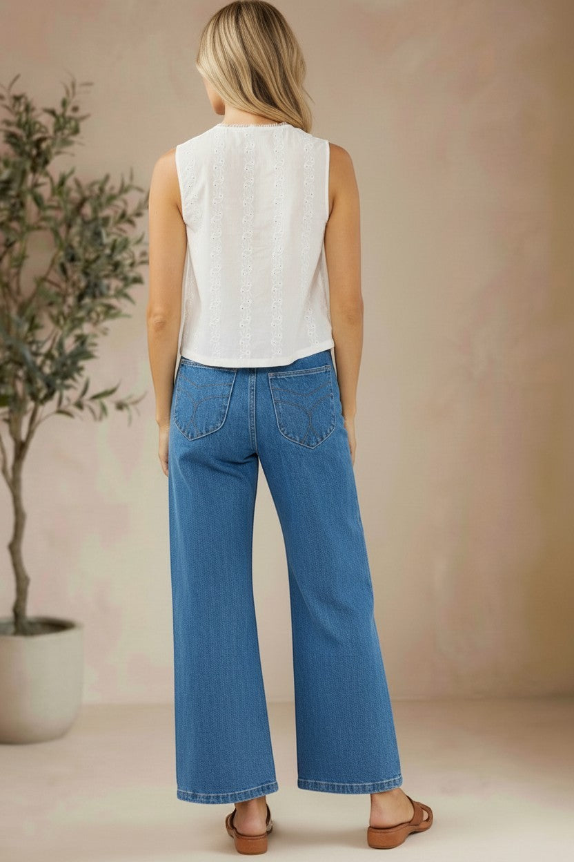White sleeveless eyelet lace tank top from Lovestitch with delicate eyelet details and a relaxed fit, perfect for casual wear.