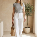 Graced white high rise wide leg jeans made from cotton blend with a flattering fit.