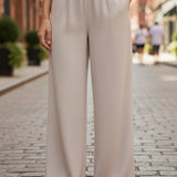 Be Cool beige flowy Tencel wide-leg pants displayed on a model, showcasing the relaxed fit and lightweight fabric.