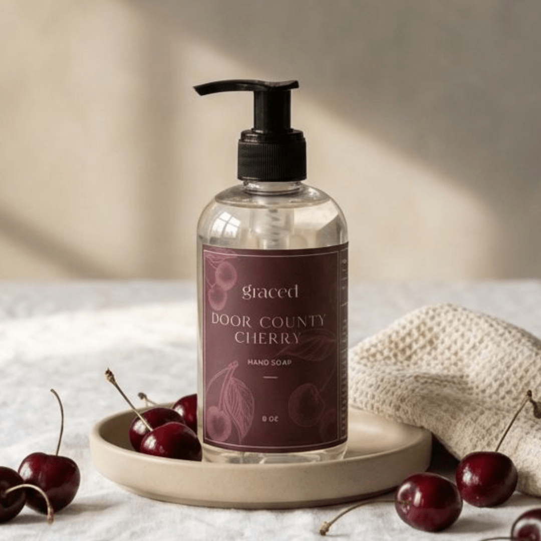 Graced Door County Cherry hand soap in an 8 oz bottle, part of bath and body lotions collection, with a cherry scent and elegant label.