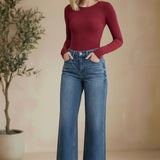 Vervet high-rise wide-leg jeans, stylish bottoms with a relaxed fit, visible in a full-length shot on a plain background.