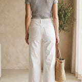 White high-rise wide-leg jeans by Vervet, displayed flat showing the relaxed fit and classic denim texture.
