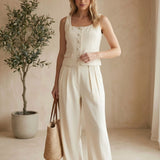 Oatmeal linen button-up top from in February, a casual basic blouse with a collar and long sleeves, laid flat.