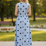 Blue sleeveless polka dot midi dress by Klesis featuring a fitted bodice and flowy skirt, made from lightweight cotton fabric.