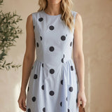 Blue sleeveless polka dot midi dress by Klesis, featuring a fitted waist and classic pattern, perfect for casual or semi-formal wear.