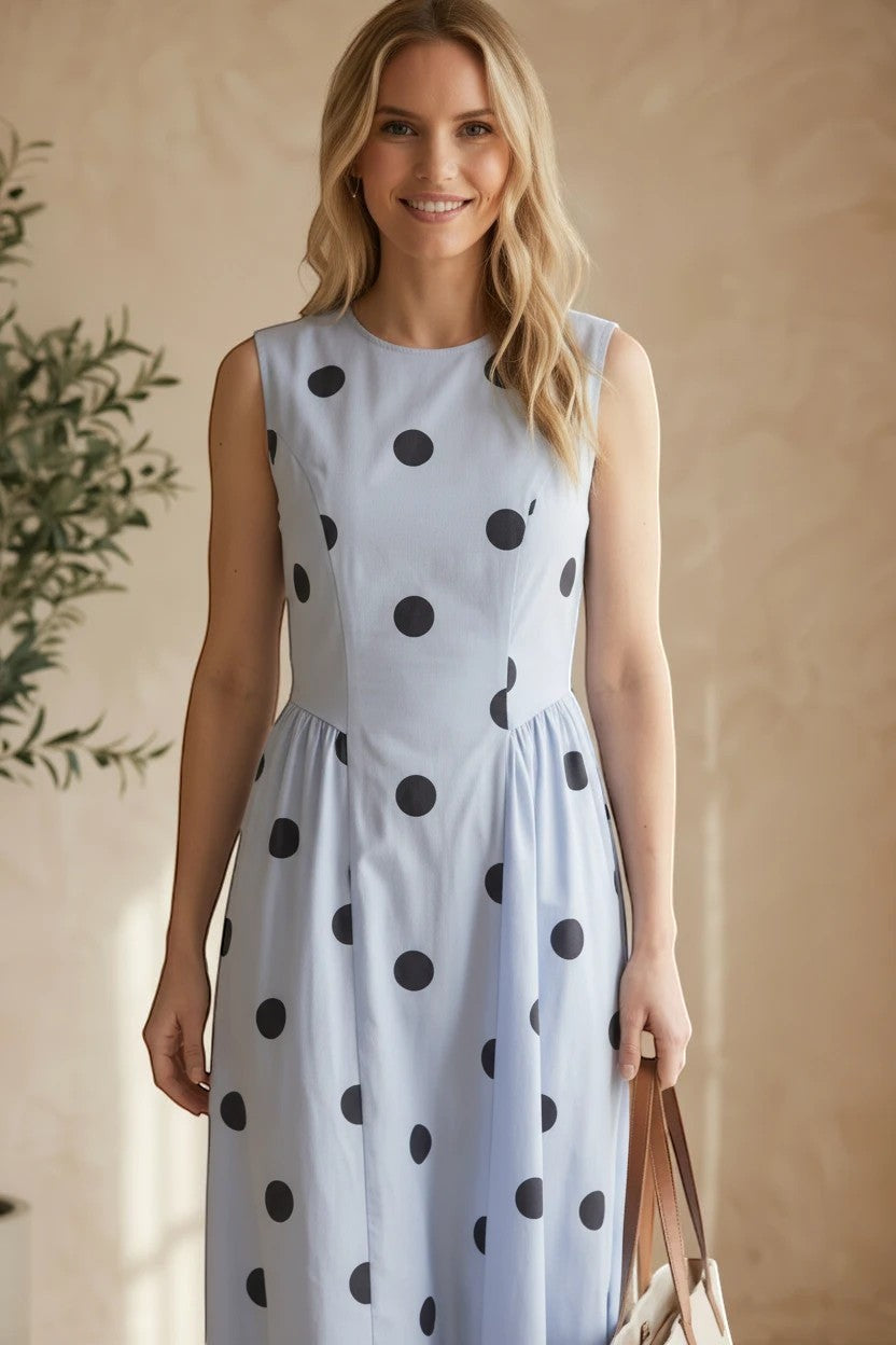 Navy blue sleeveless polka dot midi dress by Klesis, featuring a fitted waist and flowing skirt, perfect for summer occasions.