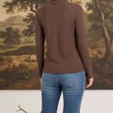 graced mocha brown long sleeve mock neck knit top worn by a woman with blonde hair in a bun, back view
