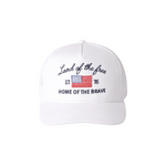 White cap with 'Land of the free Home of the Brave' text and American flag on a white background