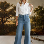 graced wide leg denim jeans with front patch pockets worn by a model in a white button-down shirt