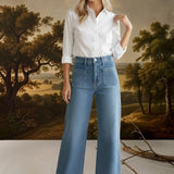 graced wide leg denim jeans with front patch pockets worn by a model in a white button-down shirt