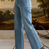 graced wide leg denim jeans with patch pockets worn by a model in a white shirt and black boots