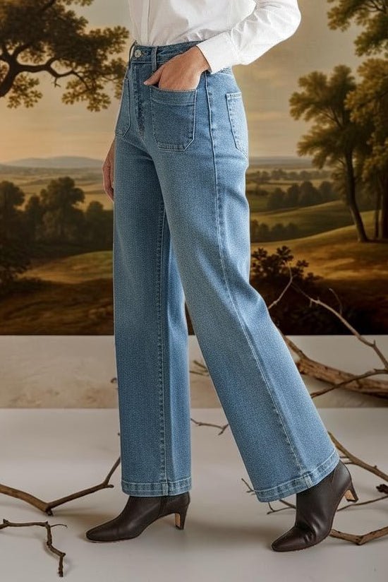 graced wide leg denim jeans with patch pockets worn by a model in a white shirt and black boots