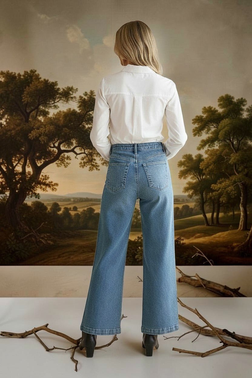 graced wide leg denim jeans with patch pockets worn by a model in a white shirt, back view