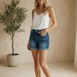 Dark wash high waisted shorts by Risen, showcasing the fit and style of these trendy denim bottoms.