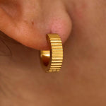 Gold Roman Huggies earrings by ALCO, stylish jewelry accessories with a classic hoop design for everyday wear.