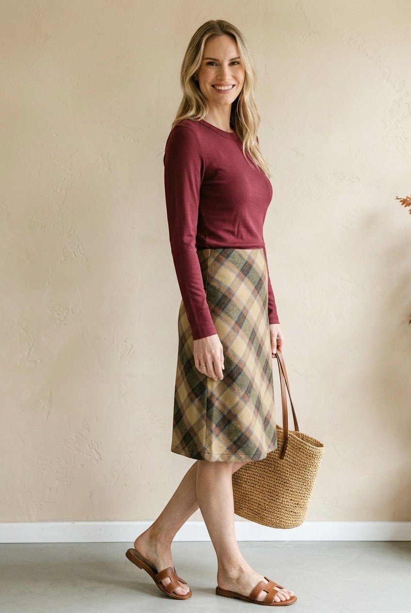 graced wine round neck knit top worn by a woman with a plaid skirt and straw tote bag