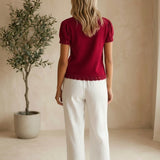 Red Camellia knit top with scallop trim and puff sleeves, featuring a stylish and feminine design.