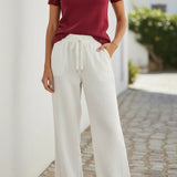 Red knit puff sleeve top with scallop trim from Camellia featuring a stylish, feminine design.