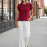 Red Camellia knit top with scallop trim and puff sleeves, featuring a stylish feminine design and detailed sleeve accents.