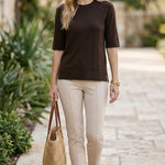 graced espresso brown short sleeve knit top worn by a woman with beige trousers and a straw tote bag