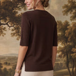 graced espresso brown short sleeve knit top with side slits worn by a woman against a landscape backdrop