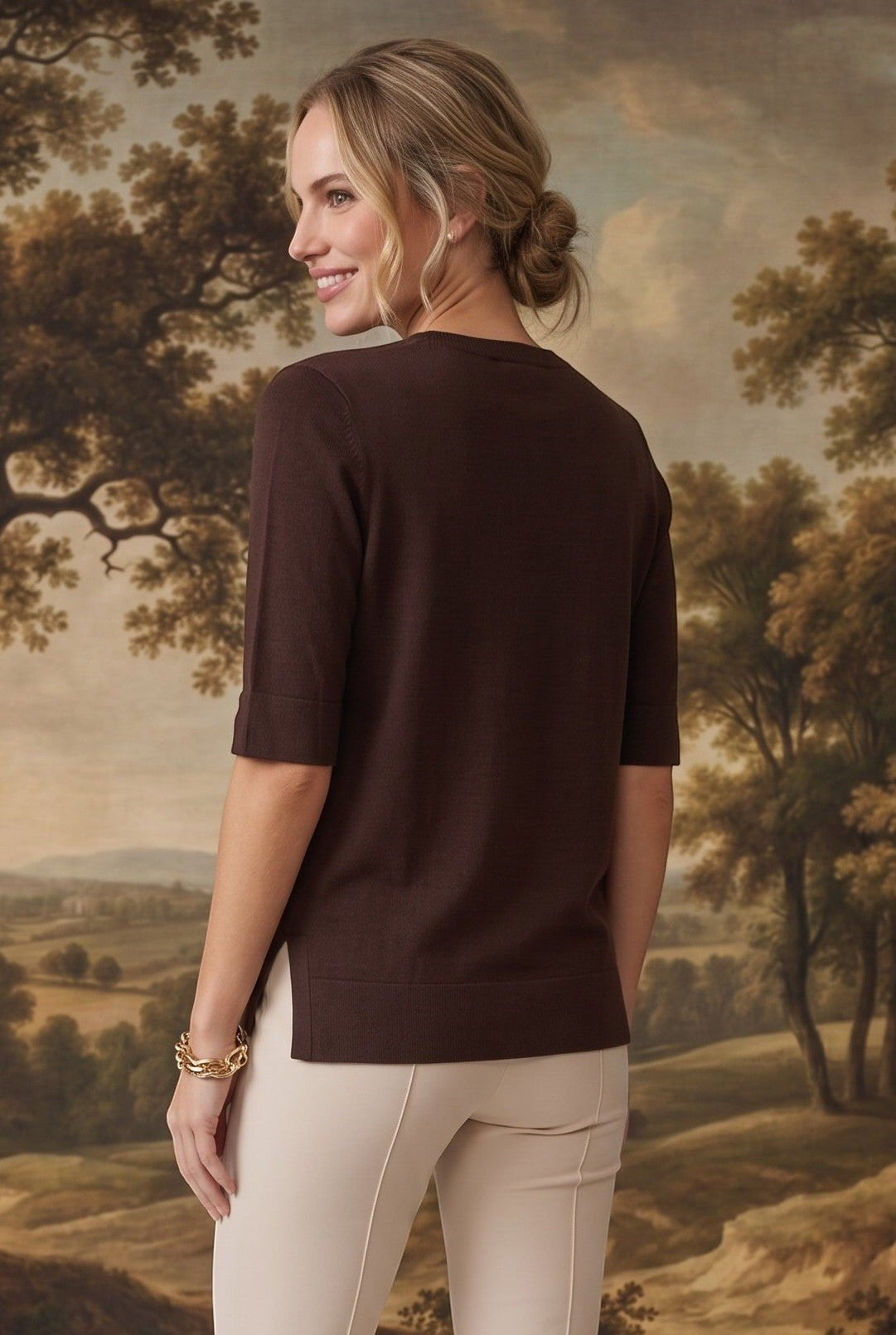 graced espresso brown short sleeve knit top with side slits worn by a woman against a landscape backdrop