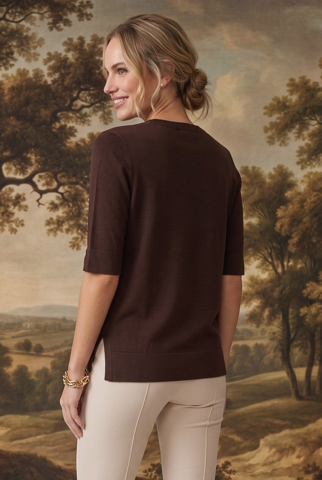 graced espresso brown short sleeve knit top with side slits worn by a woman against a landscape backdrop