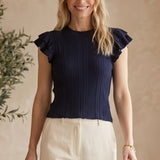Navy textured knit ruffle sleeve top by Skies are Blue, featuring a round neckline and stylish ruffle details on sleeves.
