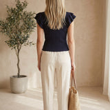 Navy textured ruffle sleeve top by Skies Are Blue, basic long-sleeve blouse with layered ruffle details, worn casual style.