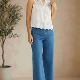 White sleeveless eyelet lace tank top by Lovestitch, featuring intricate eyelet details and a relaxed fit.