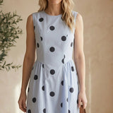 Navy blue sleeveless polka dot midi dress by Klesis, featuring a fitted waist and flowing skirt, perfect for summer occasions.