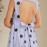 Klesis sleeveless polka dot midi dress with a fitted bodice and flowing skirt, perfect for summer occasions.