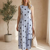 Klesis sleeveless navy blue polka dot midi dress with a fitted waist and flowing skirt, perfect for summer or casual occasions.