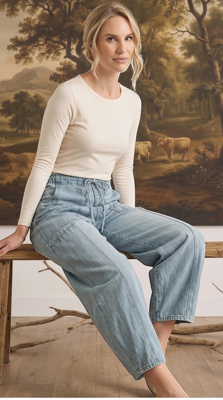 graced model wearing light wash soft denim barrel pants with a relaxed fit and drawstring waist