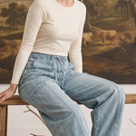 graced model wearing light wash soft denim barrel pants with a relaxed fit and drawstring waist