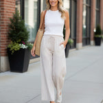 Striped smock waist pants from Allie Rose featuring a relaxed fit, high waist, and bold vertical stripe pattern.