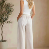 Allie Rose striped smock waist pants featuring vertical black and white stripes and a relaxed fit, casual and stylish bottoms.