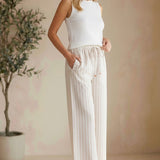 Allie Rose striped smock waist pants with a relaxed fit and vertical blue, white, and beige stripes, shown on a model.