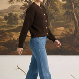 graced textured dark brown button down cardigan worn by a woman with blue jeans and beige flats