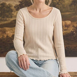 graced textured ribbed long-sleeve top in cream with a scoop neck and lettuce-edge hem worn by a smiling woman