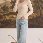 graced textured ribbed long sleeve top in beige with lettuce edge cuffs worn by a woman with light blue jeans