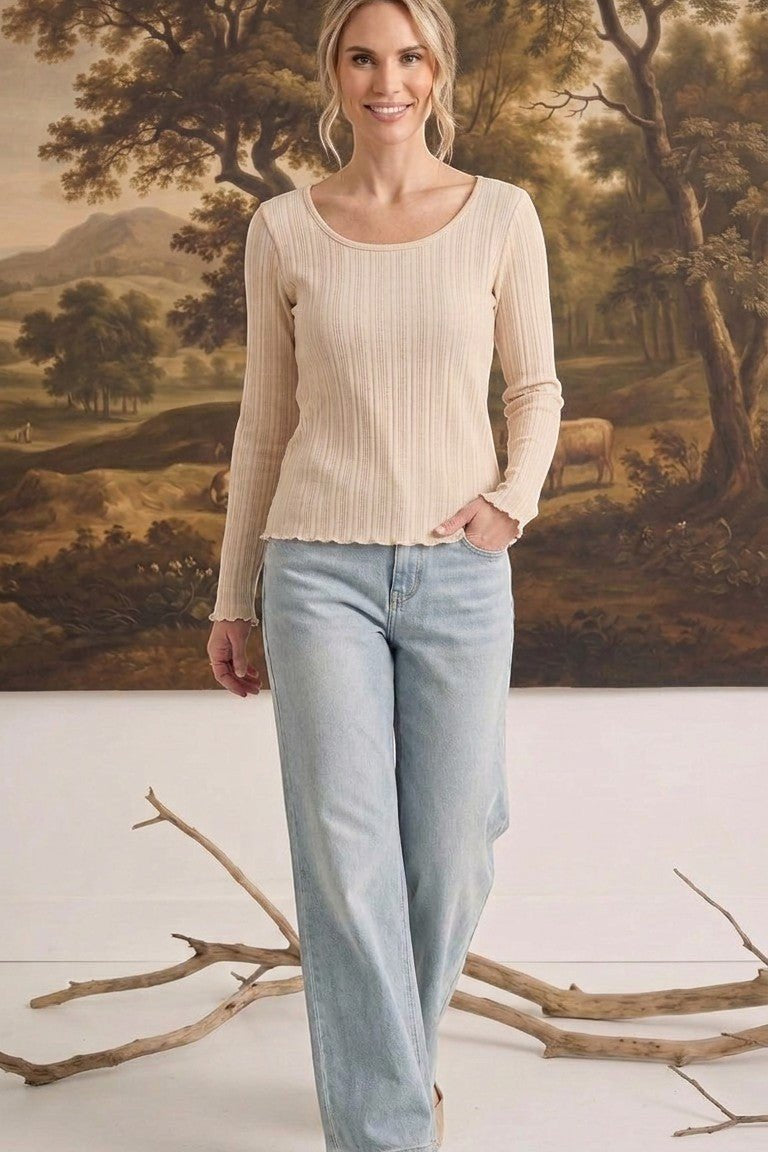 graced textured ribbed long-sleeve top in beige worn by a woman with light-wash denim jeans