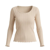 graced beige long sleeve top featuring a textured ribbed knit fabric with a scoop neckline and lettuce edge hem