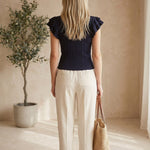 Navy textured ruffle sleeve top by Skies are Blue, featuring a stylish design with ruffled sleeves and a textured fabric.