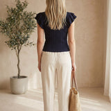 Navy textured ruffle sleeve top by Skies are Blue, featuring a stylish design with ruffled sleeves and a textured fabric.