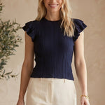 Navy textured ruffle sleeve top by Skies are Blue, featuring a close-up of the fabric and ruffle details on the sleeves.